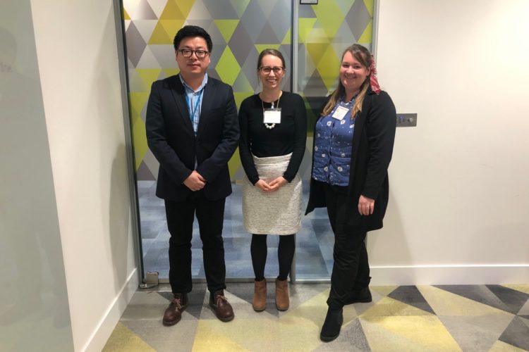 Left to right, Michael Chang, Jo Rogers and Alannah Healey smile for the camera outside of the planning office doors.