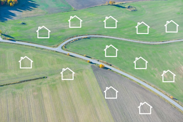 An image of a road, with fields on each side. There are outlines of houses in the fields, signifying a future housing development.