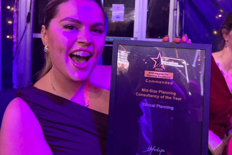 Employee Rosie holding the commended award looking very happy. Ethical Planning award-winning North East planning consultancy